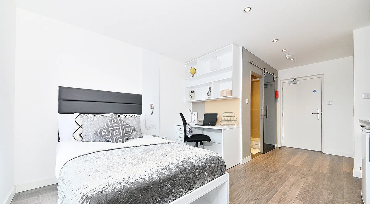 Bed desk and door of studio apartment at Miura in Nottingham Student Accommodation