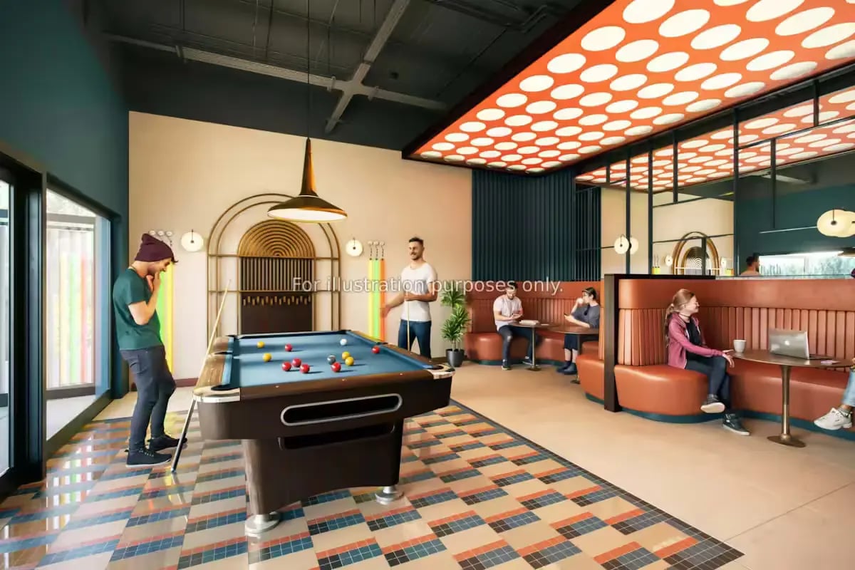 Pool table seating area with people playing and relaxing recreation area at Arcadian in Nottingham Student Accommodation