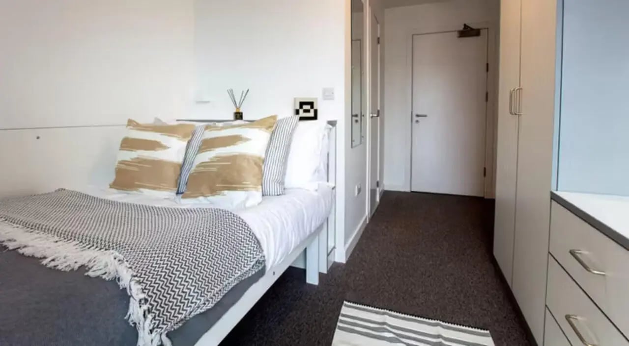 Bed with patterned pillows and throw bedroom at East Shore in St Andrews Student Accommodation