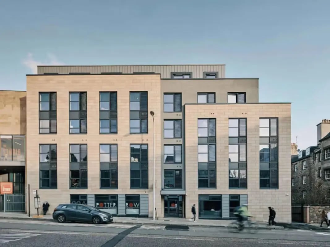 Modern student accommodation building exterior with windows and cars exterior at Potterrow in Edinburgh Student Accommodation