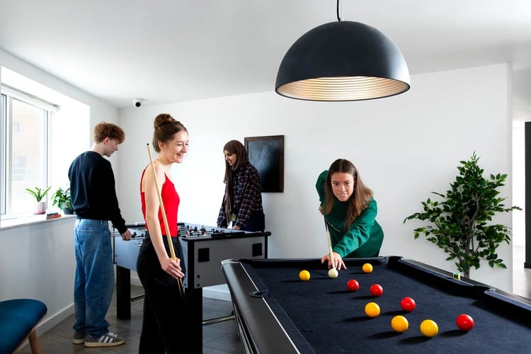 Students play pool and foosball recreation area at Castle Court in Leicester Student Accommodation