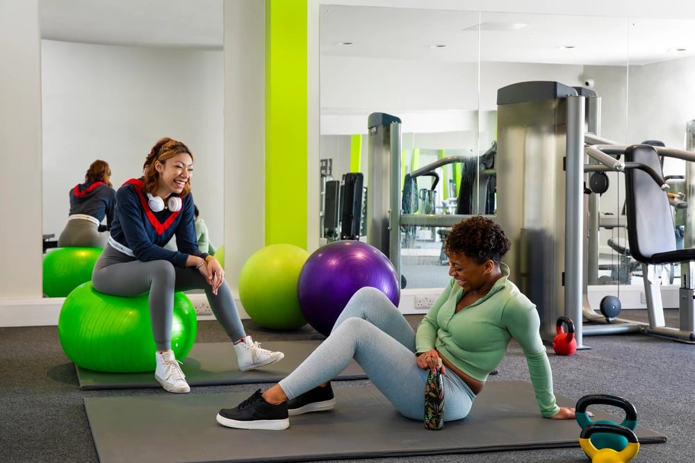 Two women exercise balls gym equipment gym at Liberty Park in Leicester Student Accommodation