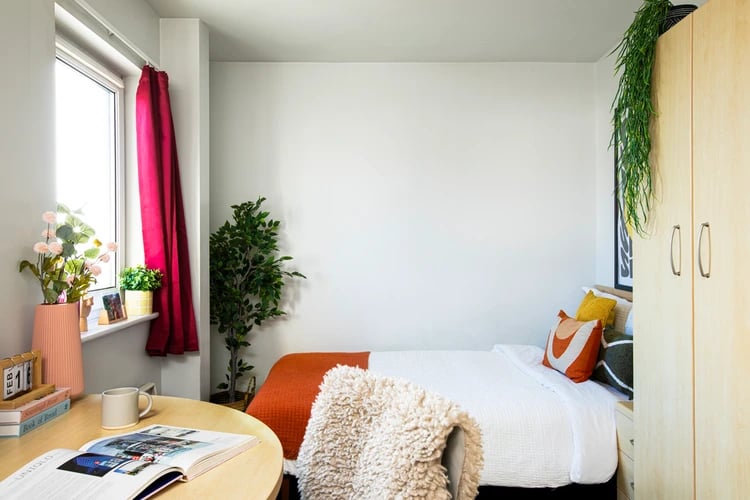 Bed desk plant wardrobe bedroom interior at Liberty Park in Leicester Student Accommodation