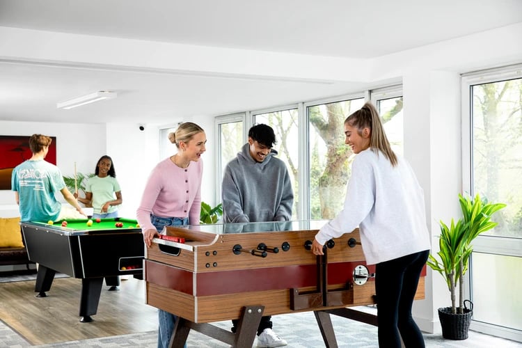 Foosball and pool tables people playing recreation area at Liberty Park in Leicester Student Accommodation