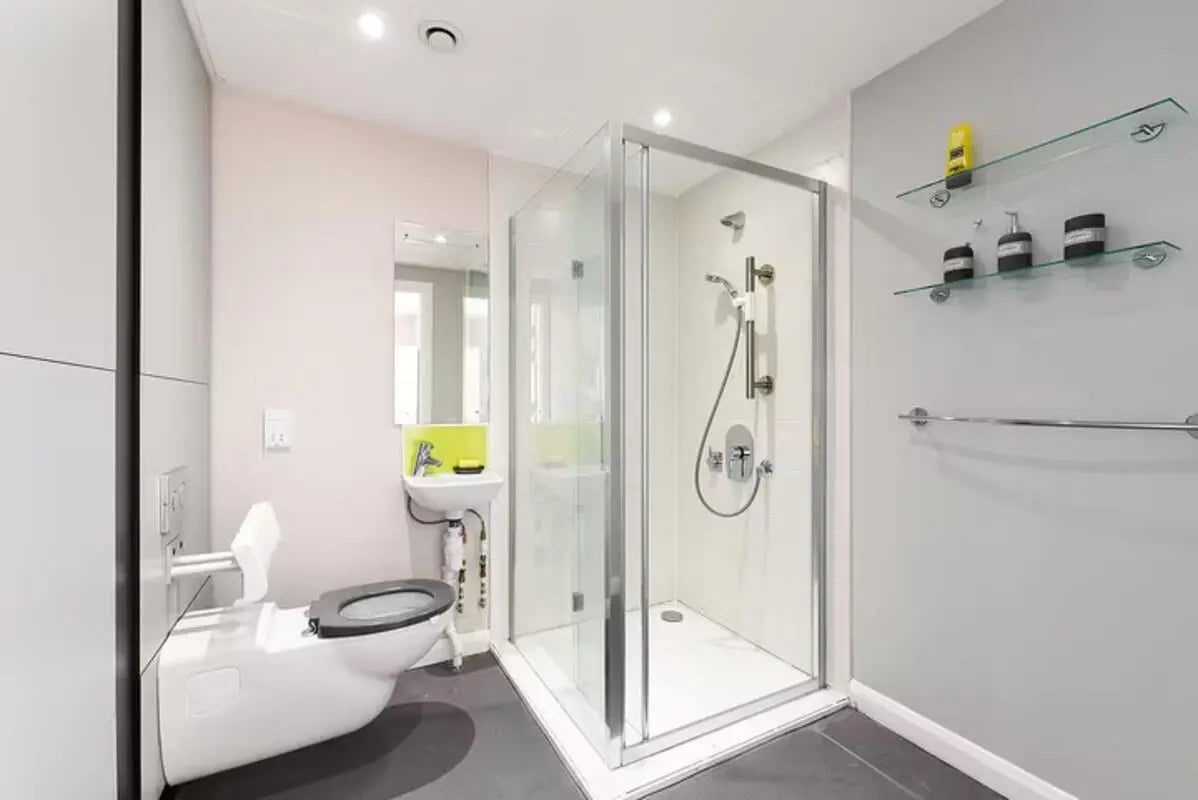 Toilet shower sink and shelves bathroom at Merchant Studios in Glasgow Student Accommodation