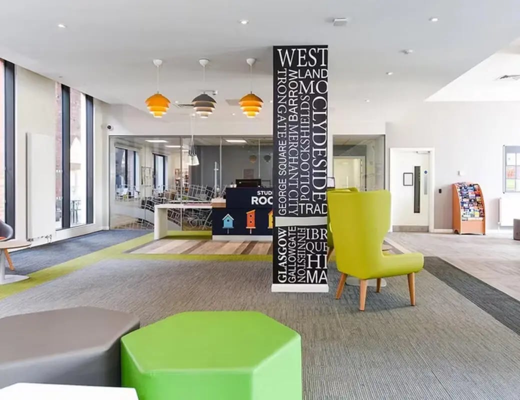 Reception desk and green chair communal area at Merchant Studios in Glasgow Student Accommodation