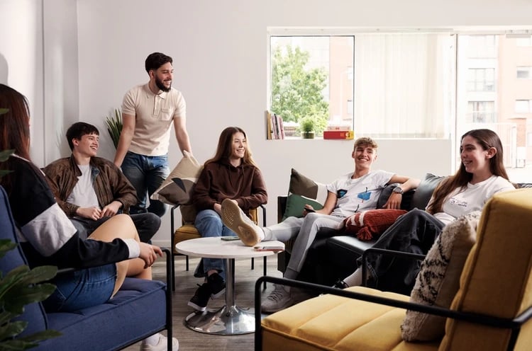 Students chatting in a communal living room at Atlantic Point in Liverpool Student Accommodation