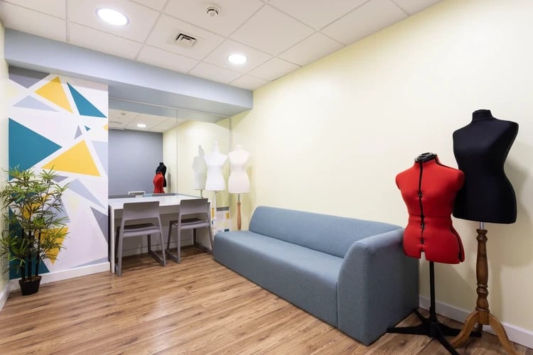 Sofa study tables mannequins and plant common room at Drapery Place in London Student Accommodation