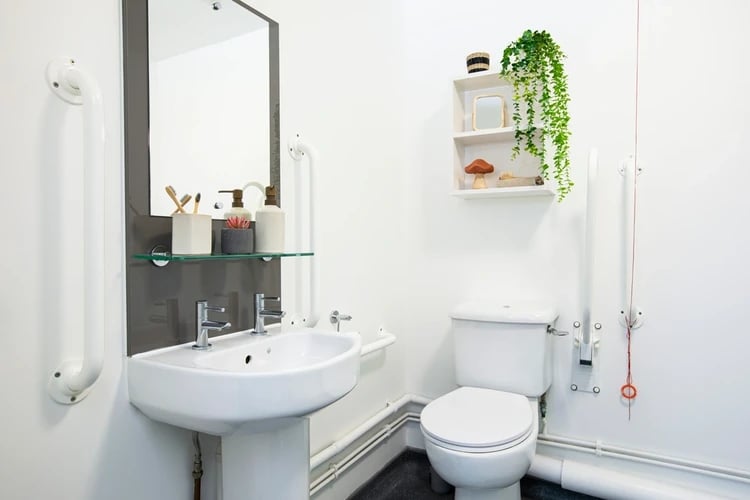 Sink toilet mirror grab bars shelves bathroom at Arbour House in London Student Accommodation