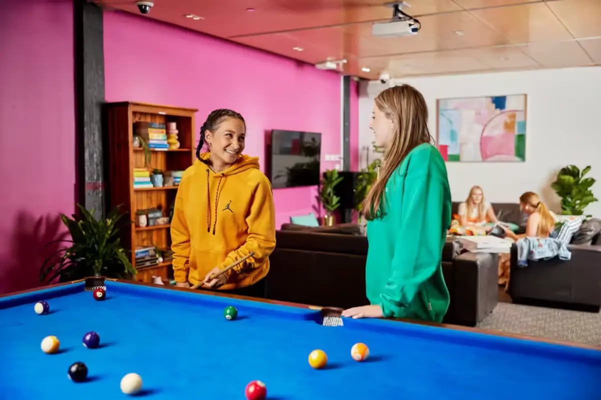 Pool table with students in common room living room at Mountain x Scape in Sydney Student Accommodation