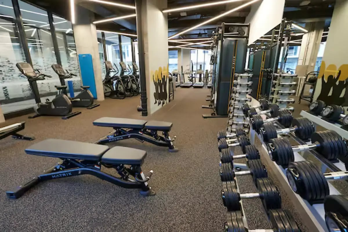 Dumbbell racks exercise bikes benches fitness gym at Scape Berkeley 2 in Melbourne Student Accommodation