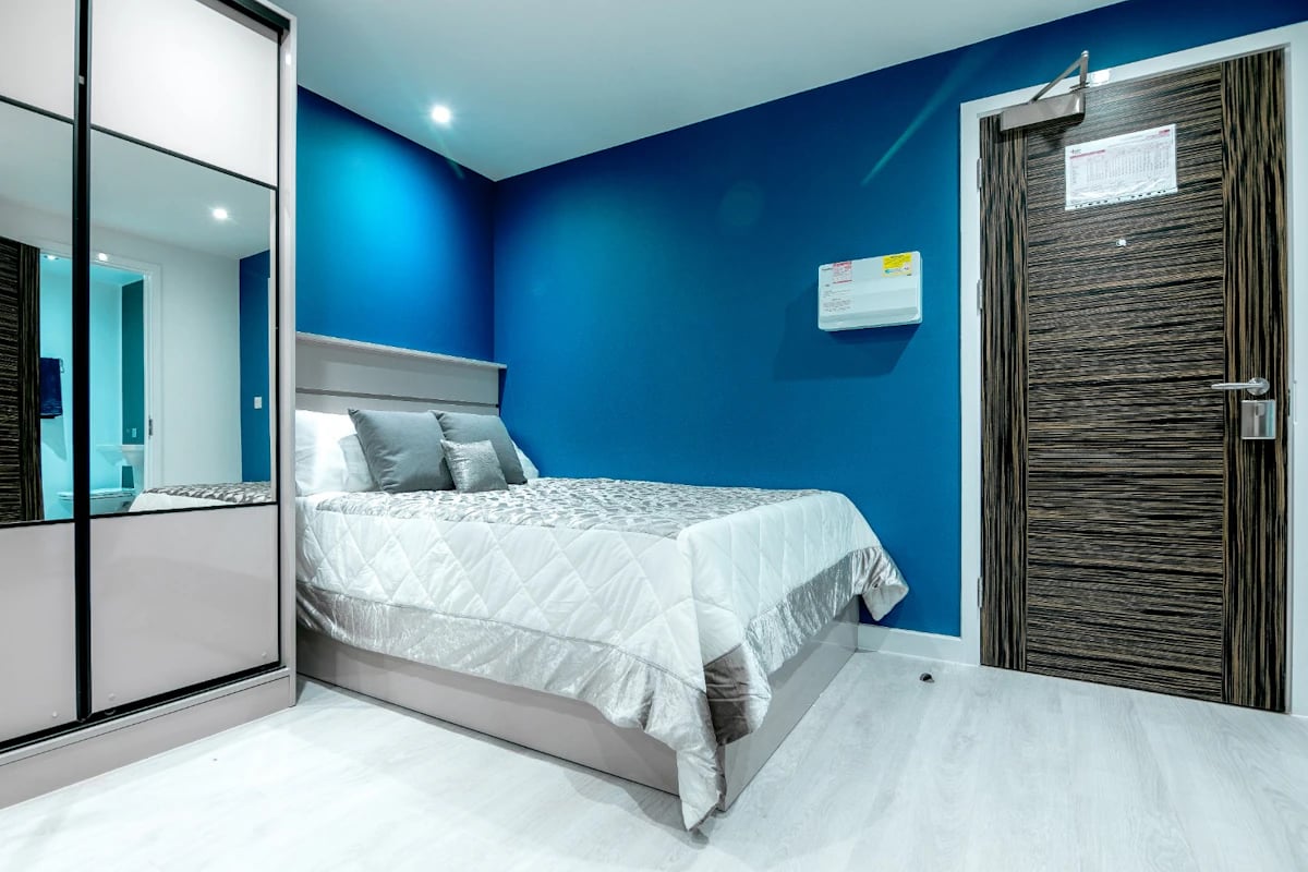 Bed wardrobe door and air conditioner bedroom at 79 Silver Street in Reading Student Accommodation