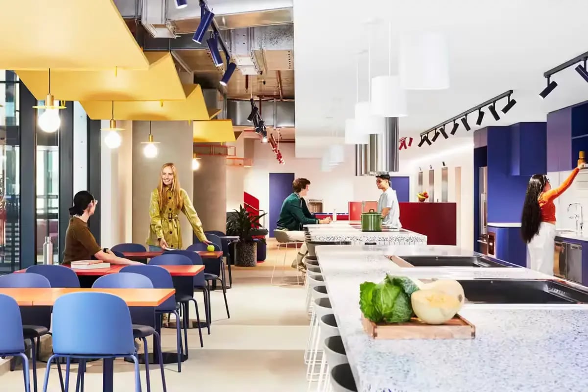 Students in lounge area and modern kitchen at Scape Lincoln College in Melbourne Student Accommodation