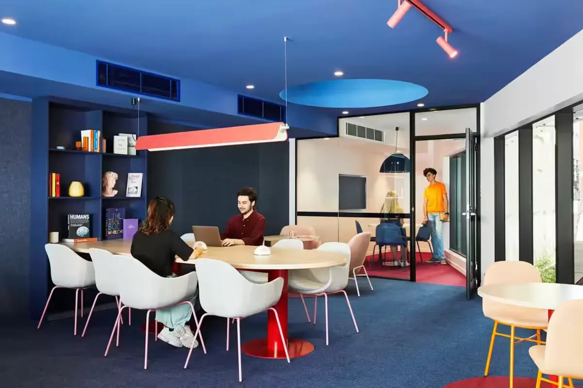 Students studying at a table communal area at Scape Lincoln College in Melbourne Student Accommodation