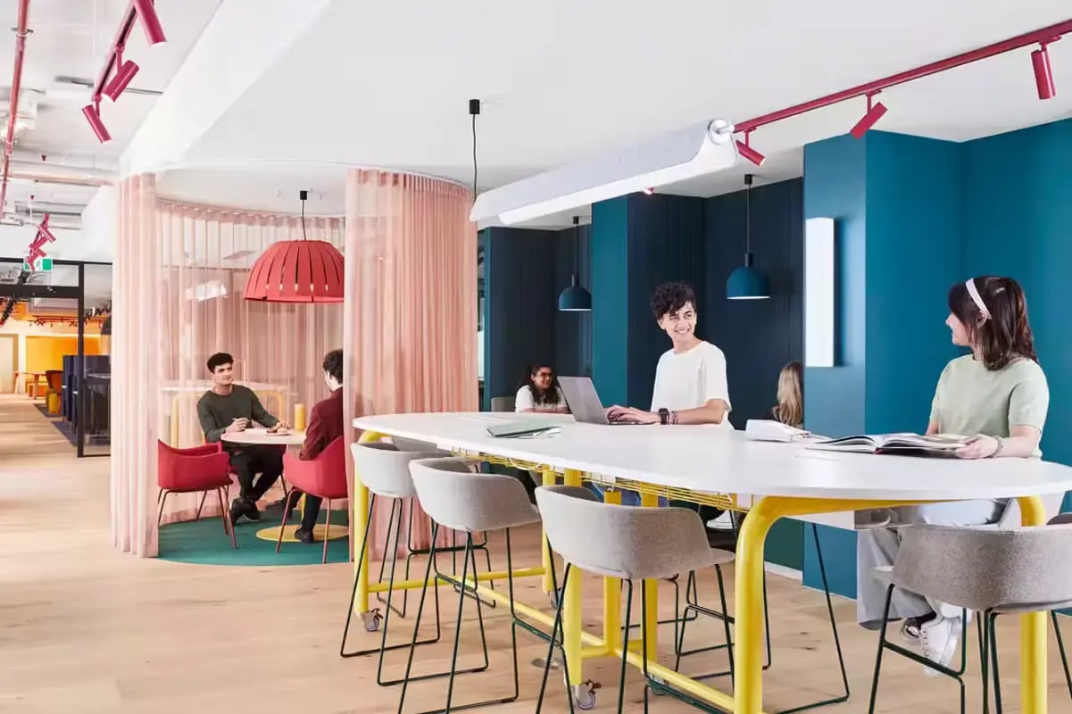 Students study at a long table study area at Scape Lincoln College in Melbourne Student Accommodation