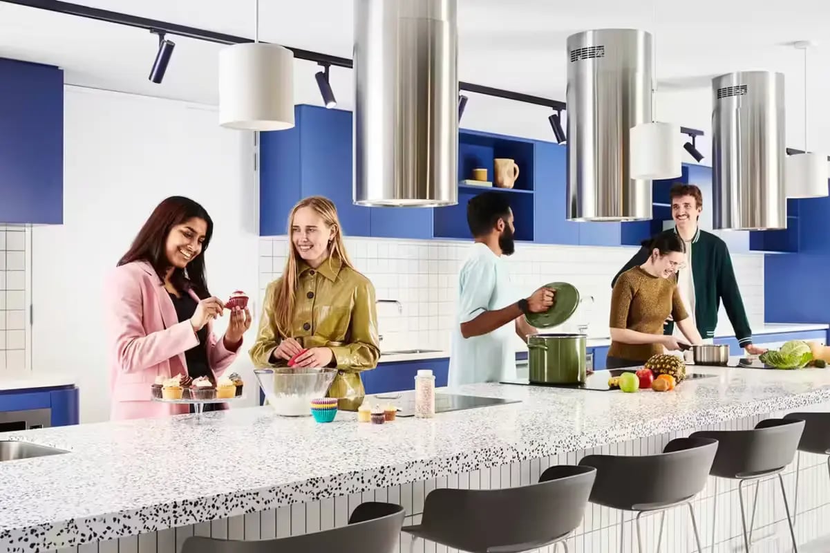 Students baking cupcakes cooking food in kitchen at Scape Lincoln College in Melbourne Student Accommodation