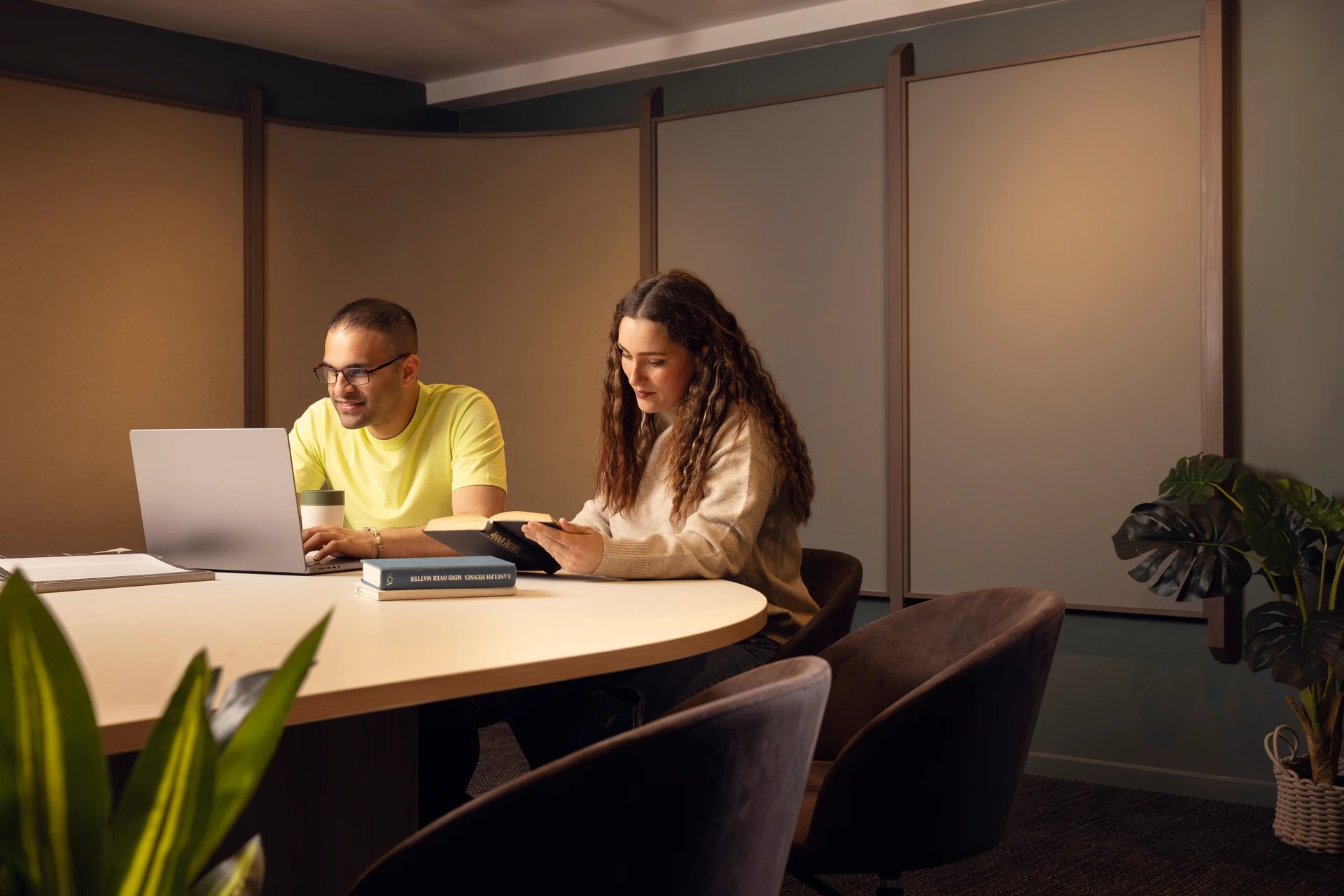 Students working at table with laptop and books study area at Bromley Place in Nottingham Student Accommodation