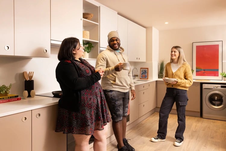 Students chatting in modern communal kitchen space at Bromley Place in Nottingham Student Accommodation