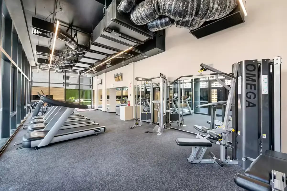 Treadmills and weight machines in gym playing area at Scape La Trobe in Melbourne Student Accommodation