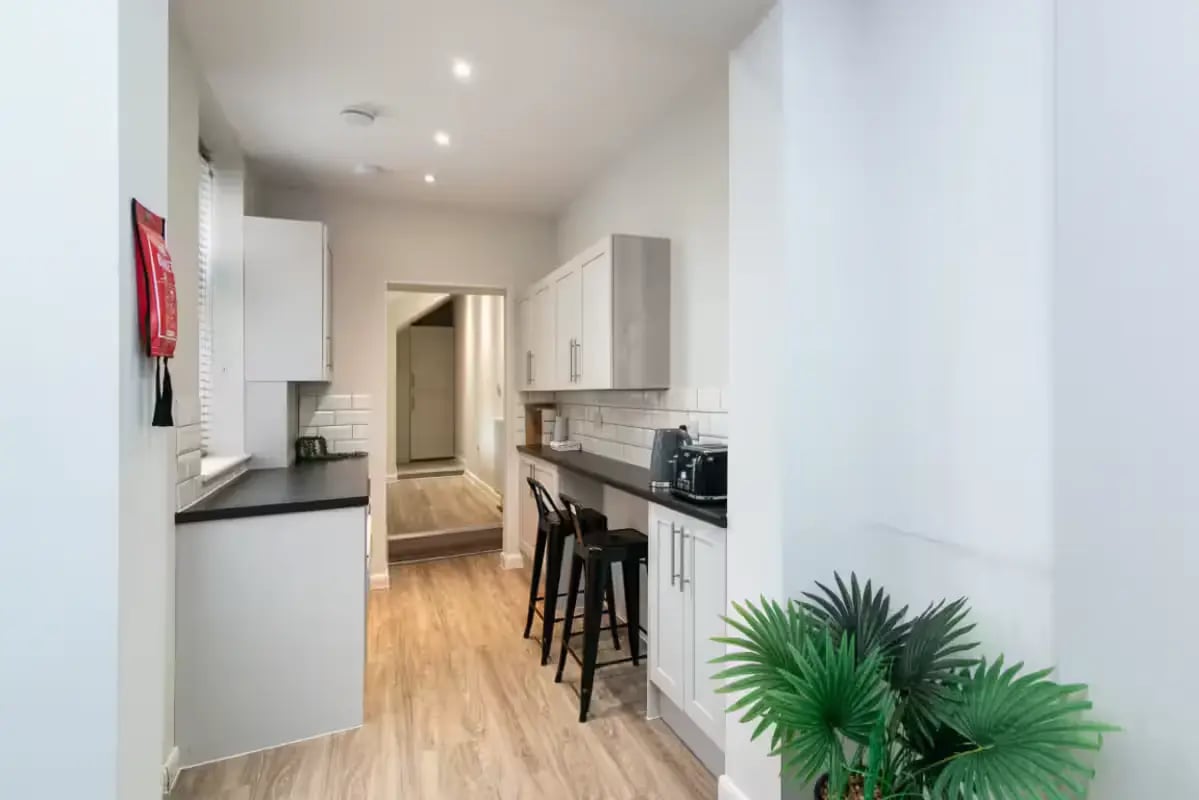 Modern kitchen with cabinets toaster and bar stools kitchen at 32 Cauldon Road in Stoke-On-Trent Student Accommodation
