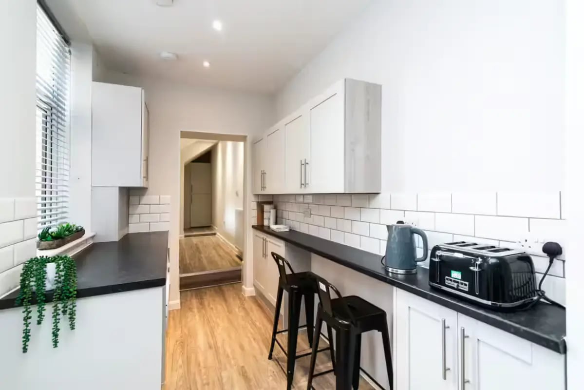 Kitchen with two bar stools and appliances kitchen at 32 Cauldon Road in Stoke-On-Trent Student Accommodation