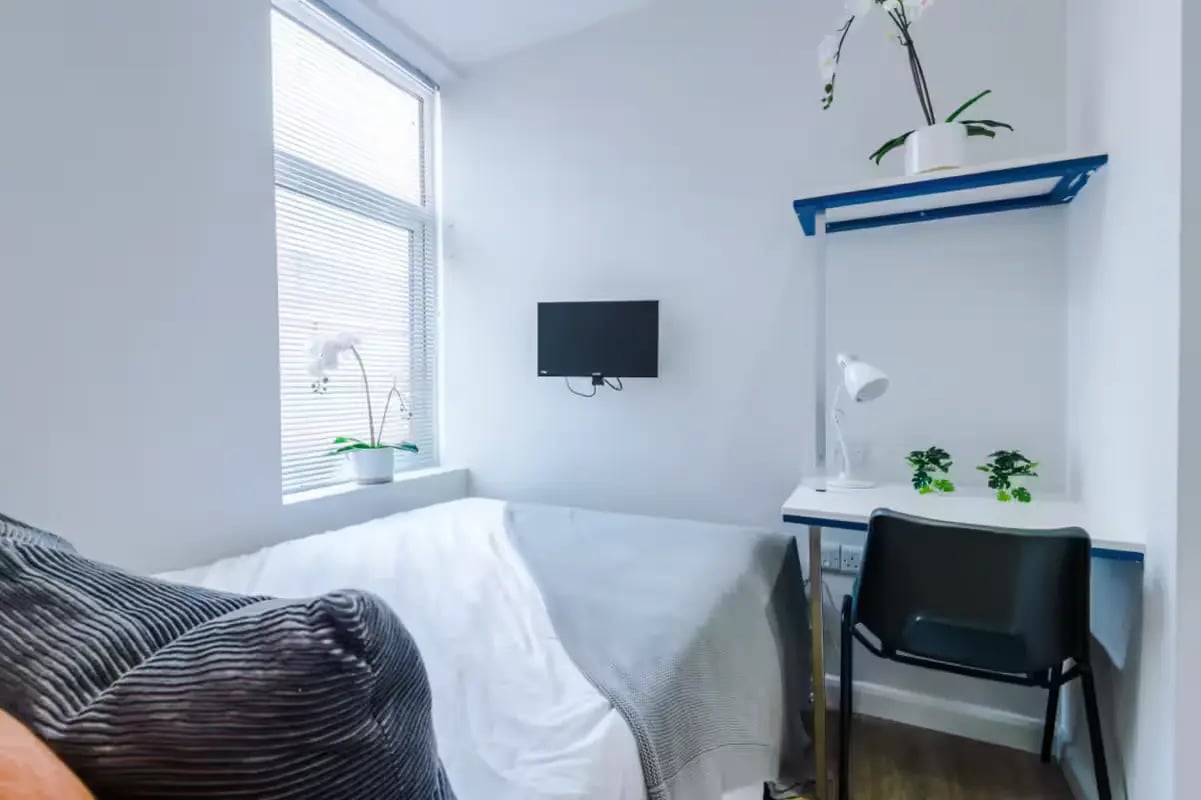 Bed desk chair television and plants bedroom at 32 Cauldon Road in Stoke-On-Trent Student Accommodation