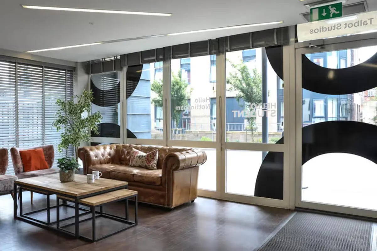 Leather sofa nesting tables plant living room at Talbot Studios in Nottingham Student Accommodation
