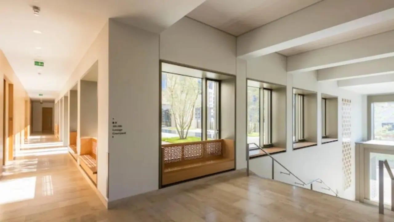 Hallway with benches and large windows communal area at Victoria Hall Kings Cross in London Student Accommodation