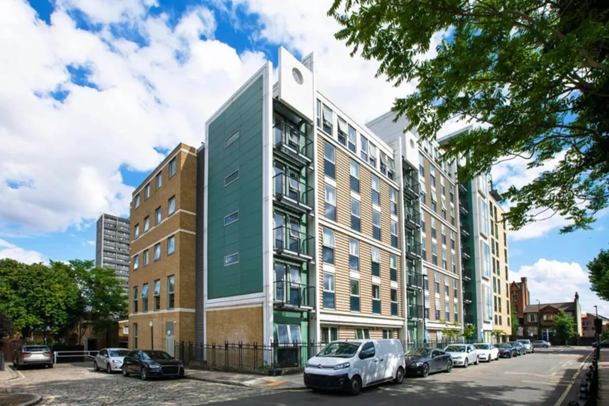 Modern student accommodation building with parked cars exterior at Quantum Court in London Student Accommodation