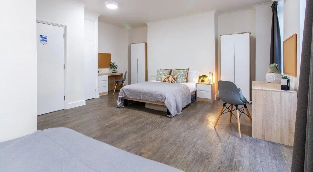Bed desk wardrobe chair and nightstand bedroom at Bloomsbury Janet Poole House in London Student Accommodation