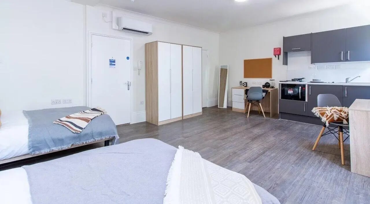Two beds wardrobe kitchen study area studio at Bloomsbury Janet Poole House in London Student Accommodation