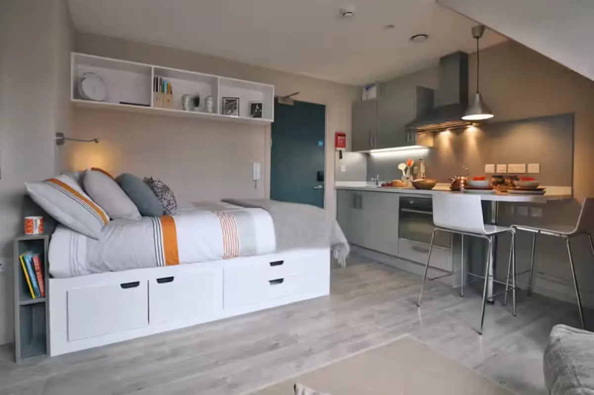 Bed kitchen counter and bar stools studio apartment at The Frontage in Nottingham Student Accommodation