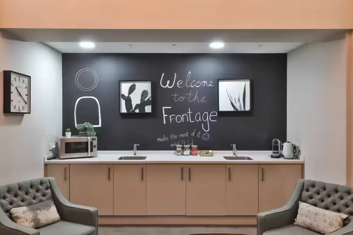 Chalkboard sign microwave sinks and chairs kitchen at The Frontage in Nottingham Student Accommodation