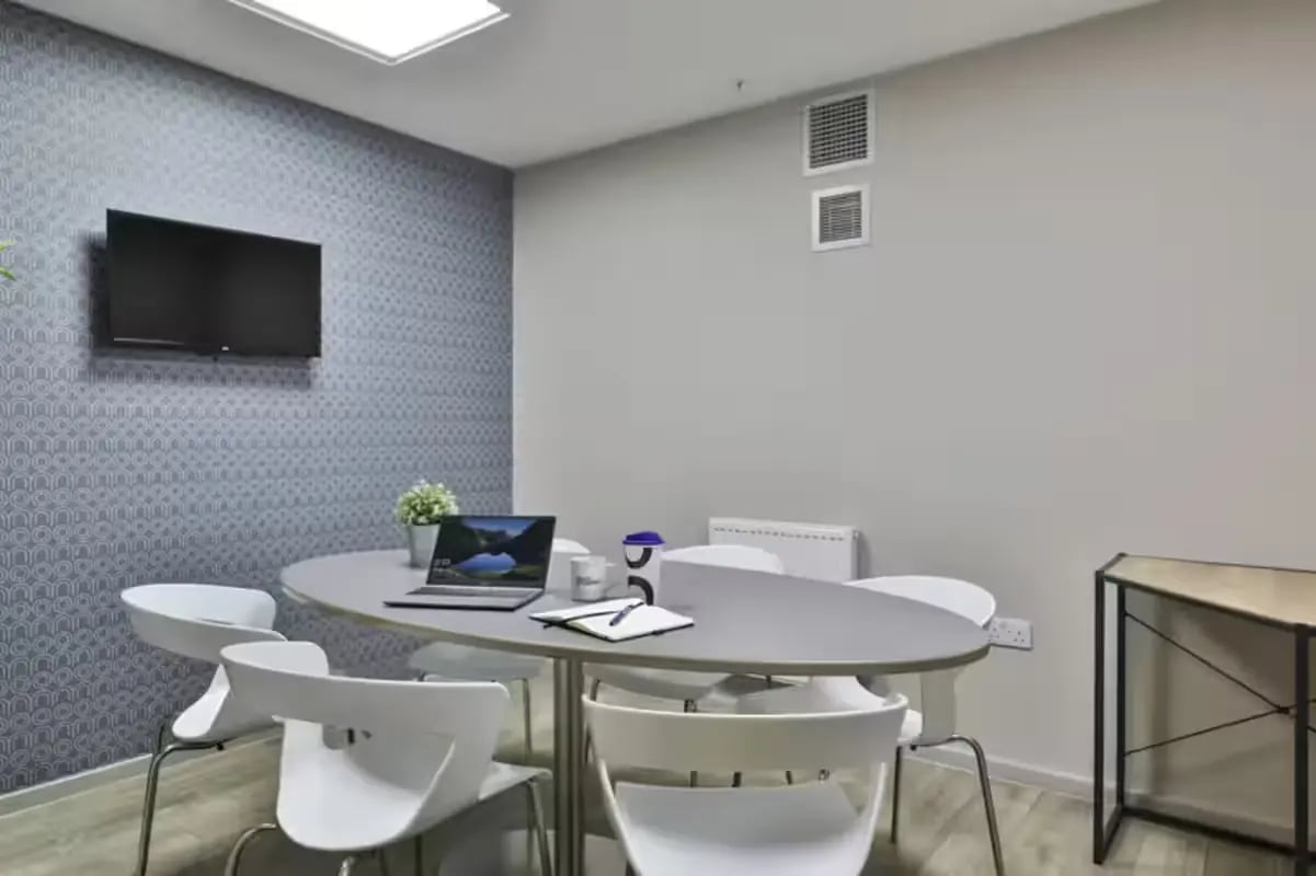 Table with laptop and chairs study area at The Frontage in Nottingham Student Accommodation