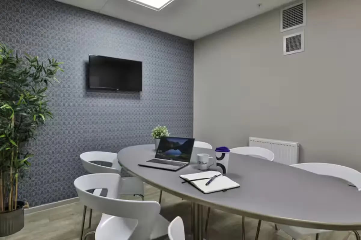 Oval table laptop notebook chairs meeting room at The Frontage in Nottingham Student Accommodation