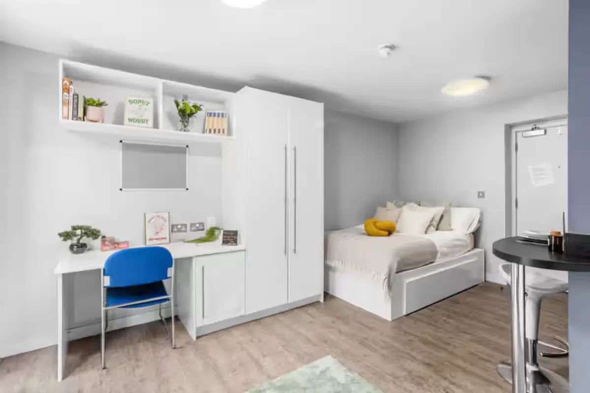 Bed wardrobe desk and chair bedroom living room at Alwyn Court in Cardiff Student Accommodation