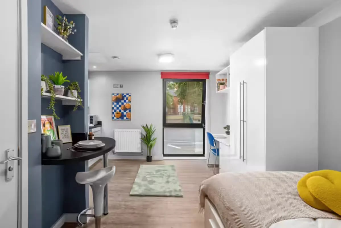 Studio room with desk bed and kitchen bedroom at Alwyn Court in Cardiff Student Accommodation