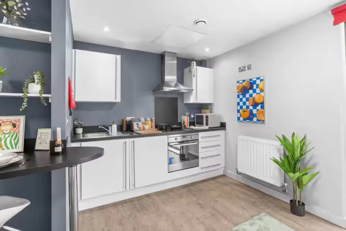 Modern white kitchen with dining bar kitchen at Alwyn Court in Cardiff Student Accommodation