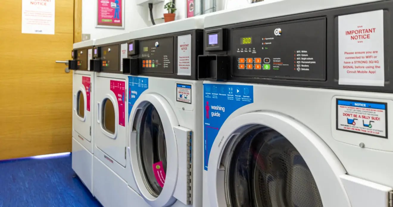 Washing machines with notices laundry room exterior at Kaplan Living Glasgow - Argyle Street in Glasgow Student Accommodation