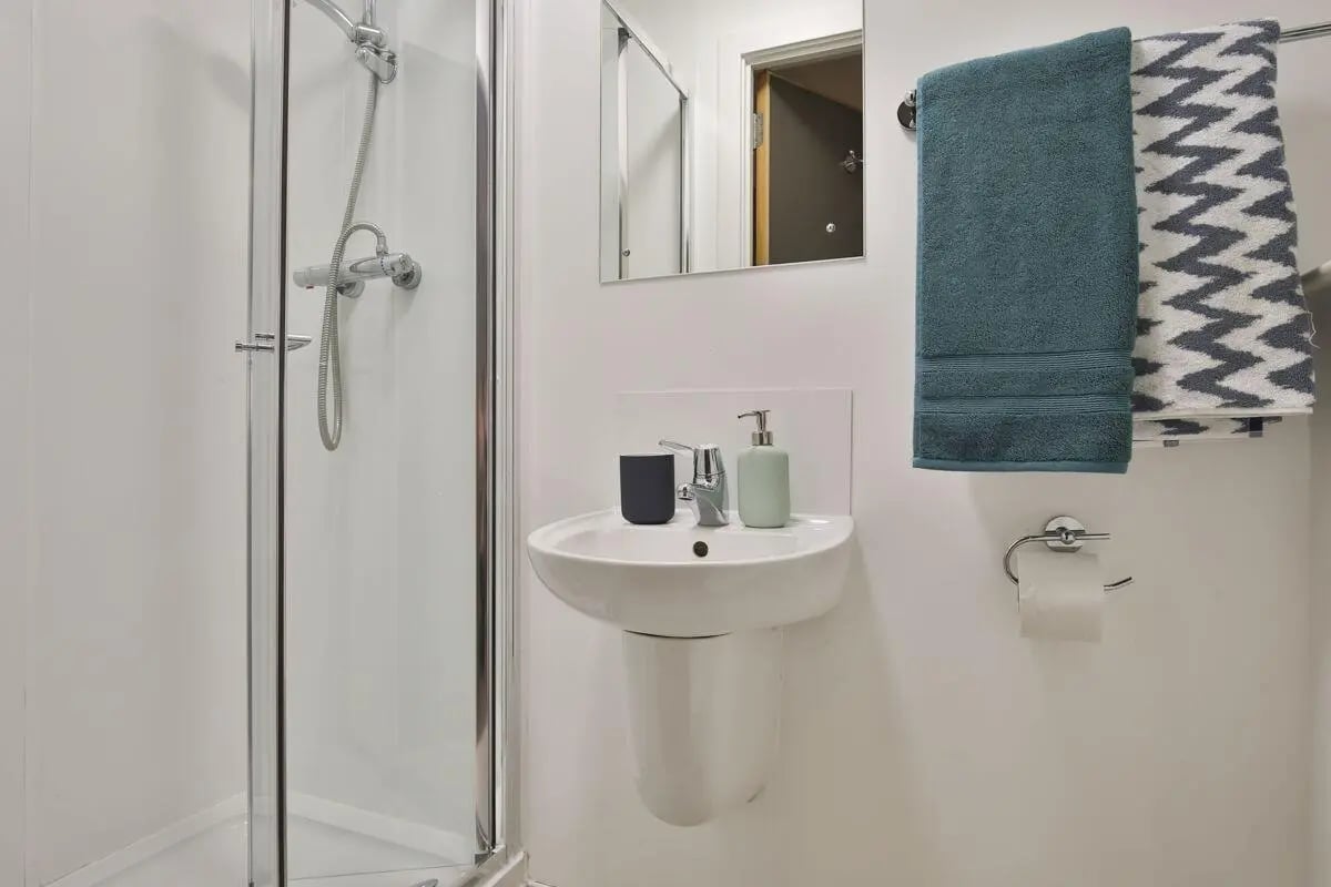 Shower sink dispenser soap towels mirror bathroom at Bath Street in Glasgow Student Accommodation