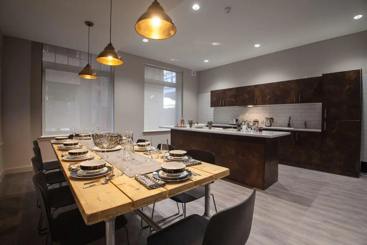 Table with place settings and kitchen island kitchen at Bath Street in Glasgow Student Accommodation