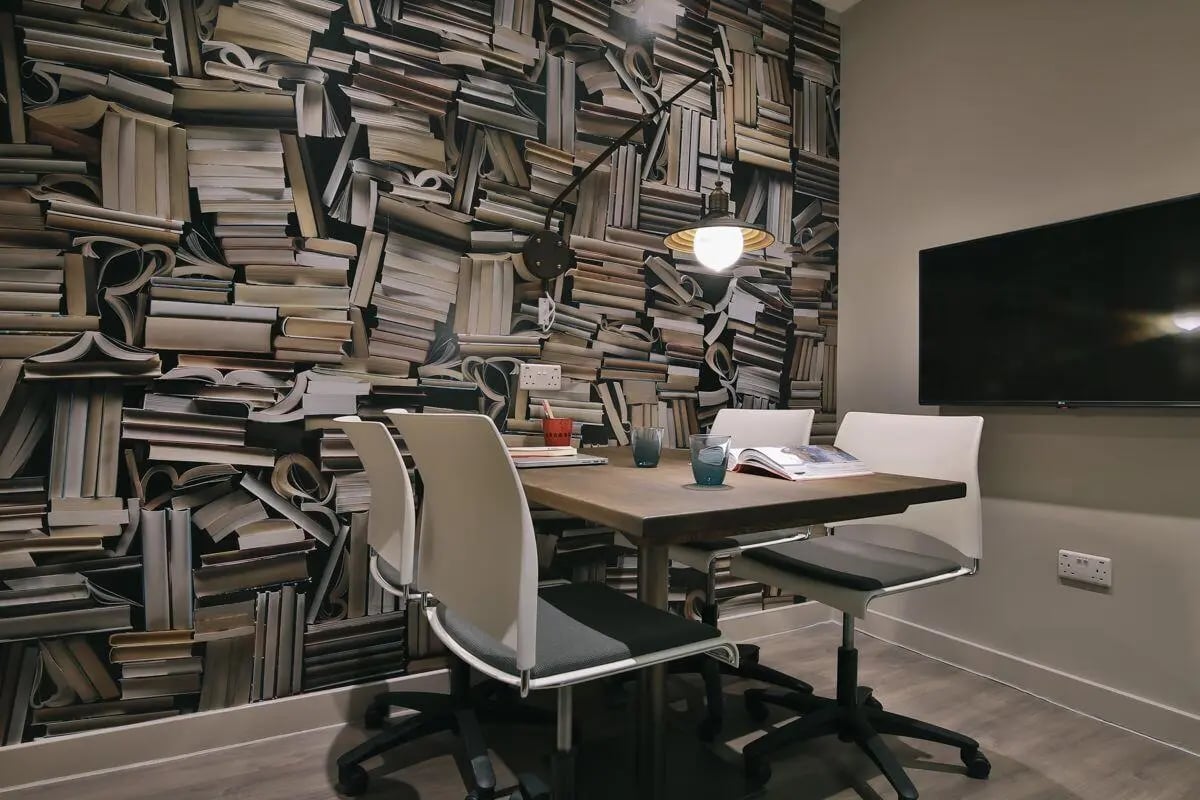 Table chairs lamp wallpaper and television study area at Bath Street in Glasgow Student Accommodation