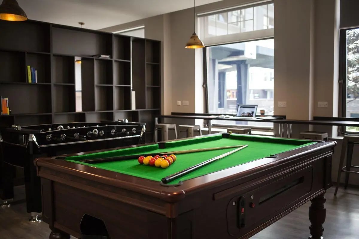 Pool table foosball table bookshelves living room at Bath Street in Glasgow Student Accommodation