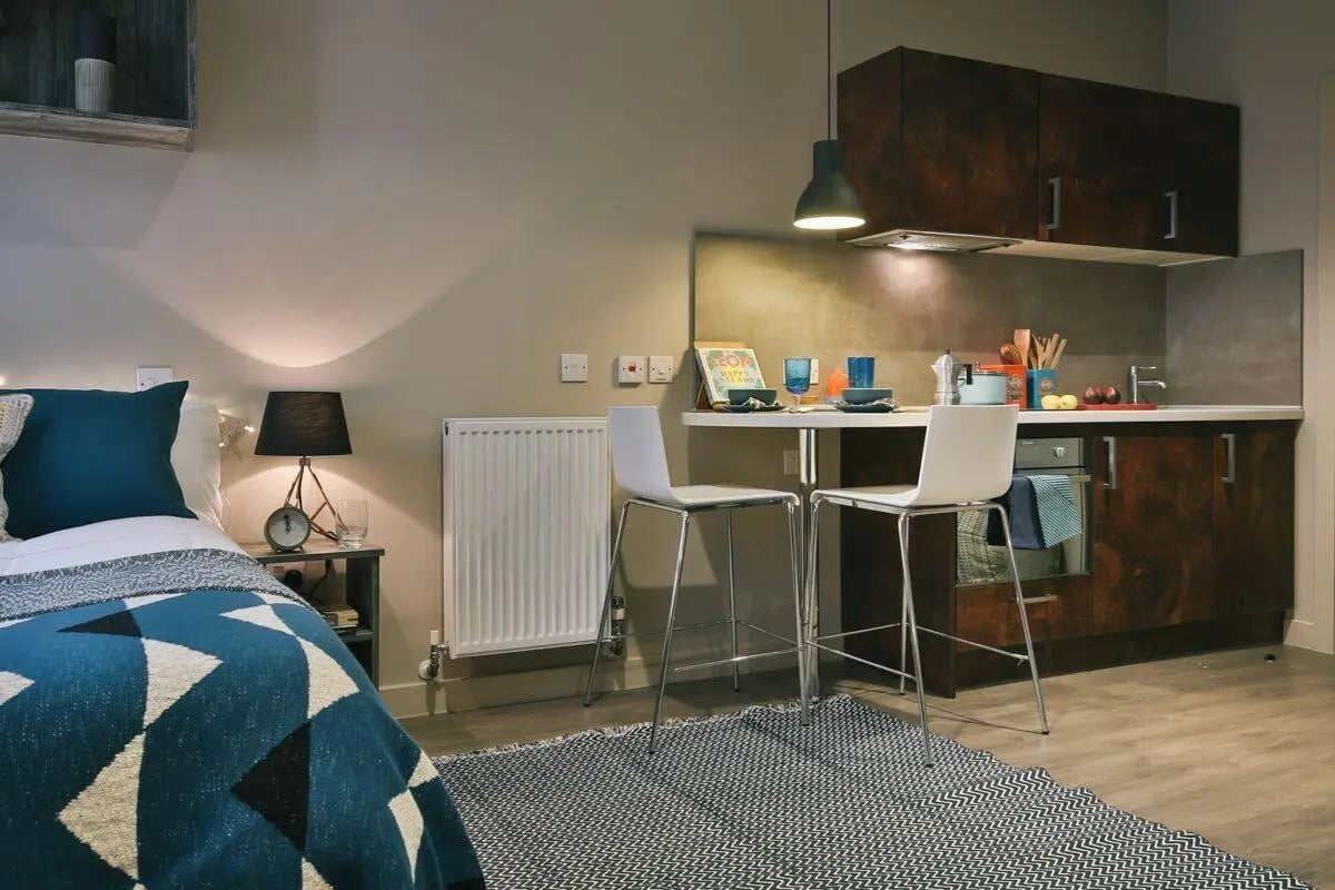Bed kitchen with breakfast bar and stools studio room at Bath Street in Glasgow Student Accommodation