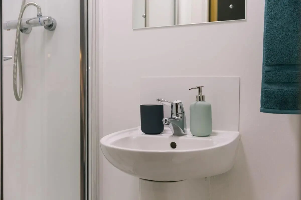 Sink shower dispenser and towel Bathroom at Bath Street in Glasgow Student Accommodation