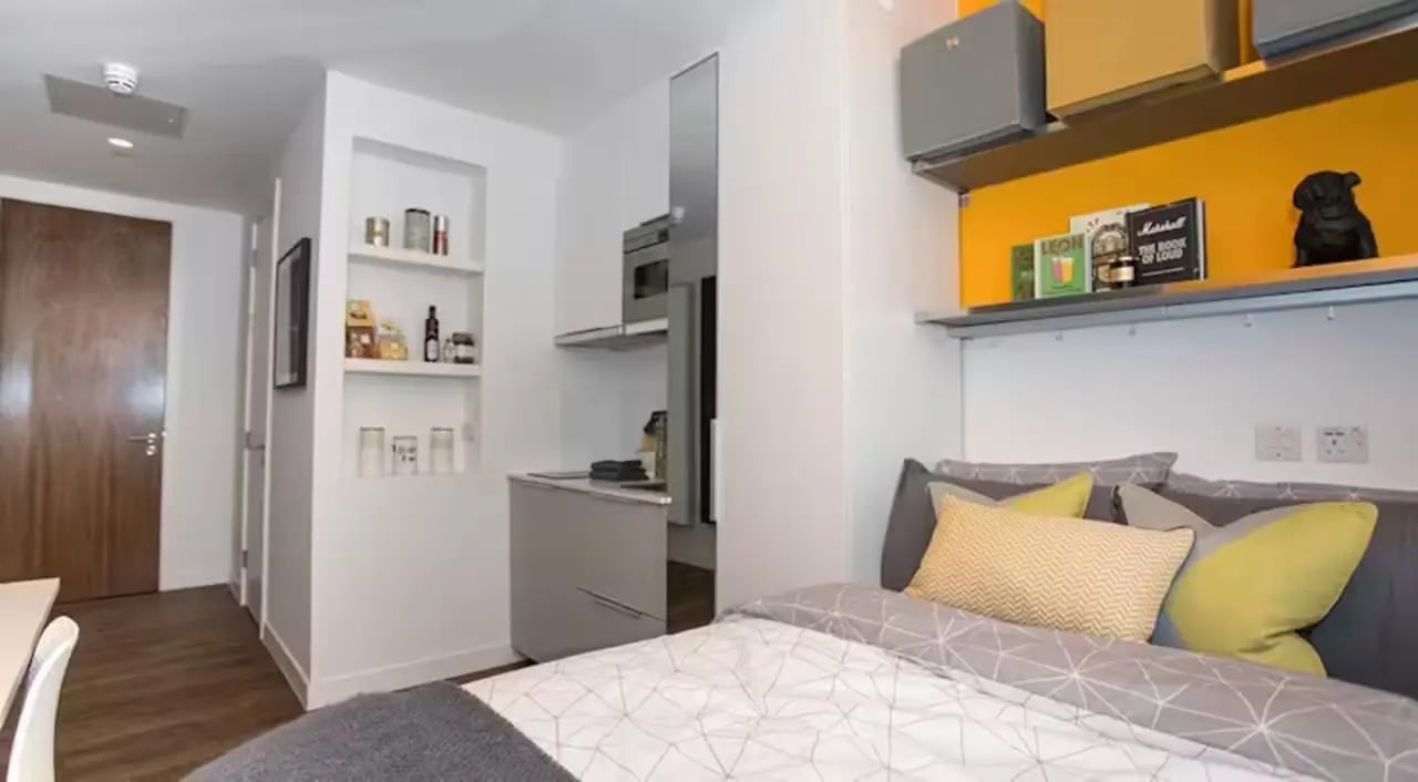 Bed with kitchen and shelves Bedroom at Riverside Glasgow in Glasgow Student Accommodation