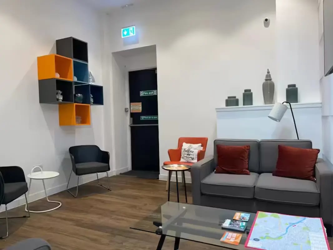 Sofa chairs shelves and coffee table living room at Riverside Glasgow in Glasgow Student Accommodation
