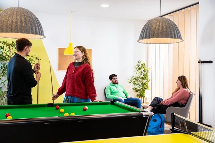 Pool table and people playing recreation area at Brunel House in Bristol Student Accommodation