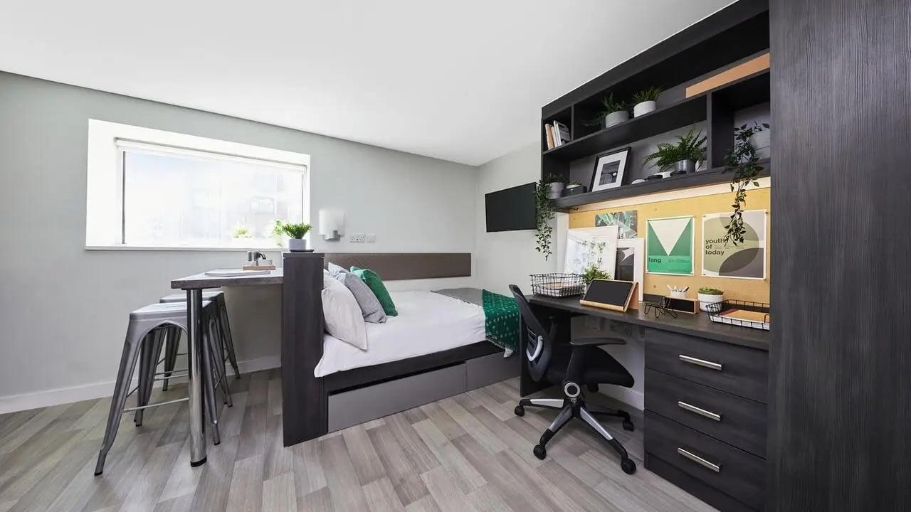 Bed desk storage shelving with plants student room at Collegiate Tower in Bristol Student Accommodation