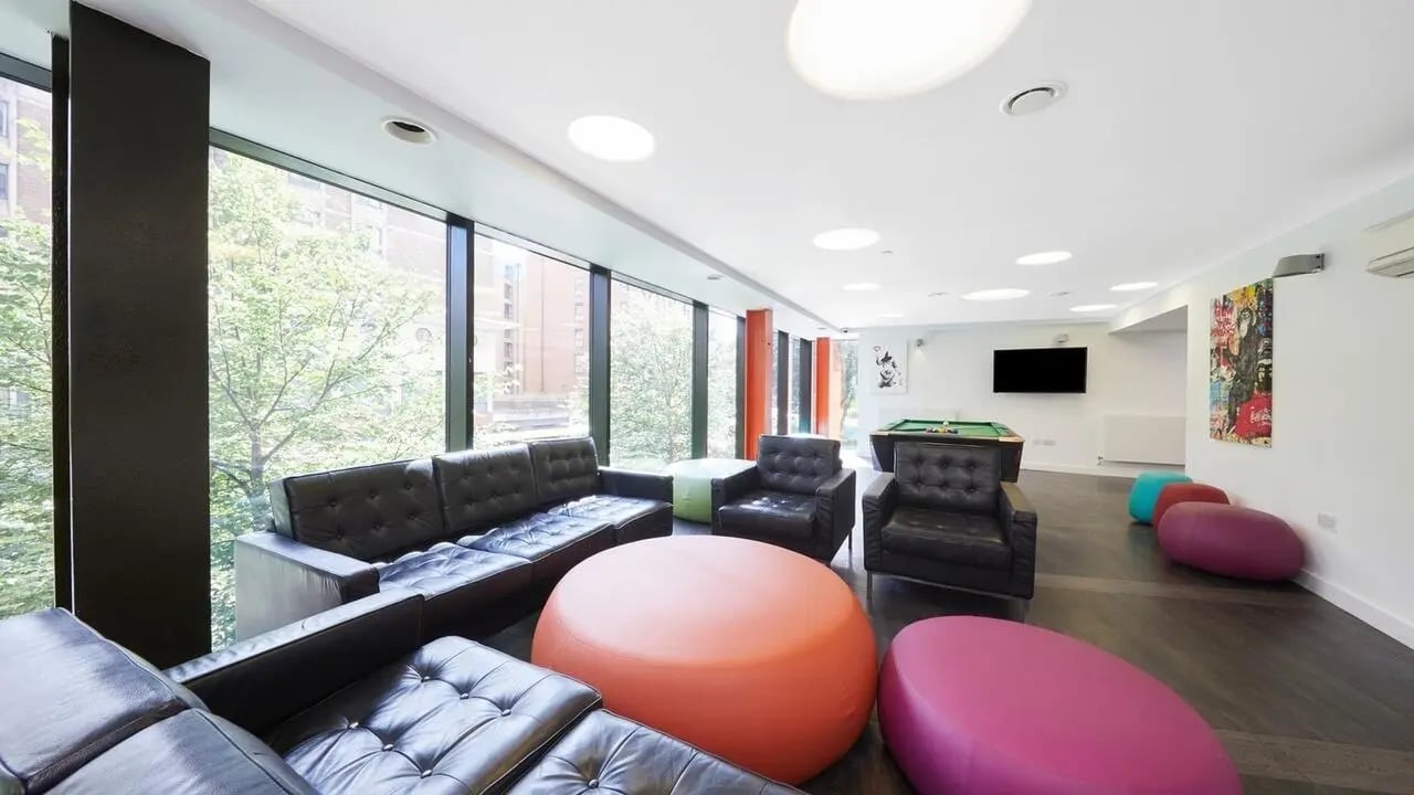 Leather sofas armchairs pool table lounge area at Collegiate Tower in Bristol Student Accommodation